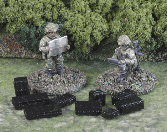 15mm scale modern equipment cases miniatures in black resin with two painted soldier figures on grassy terrain