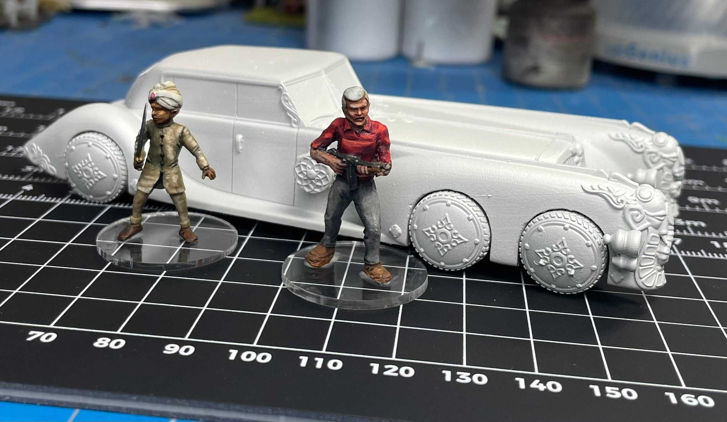 28mm scale resin 3D printed extraordinary car model with two detailed miniature figures on a cutting mat.