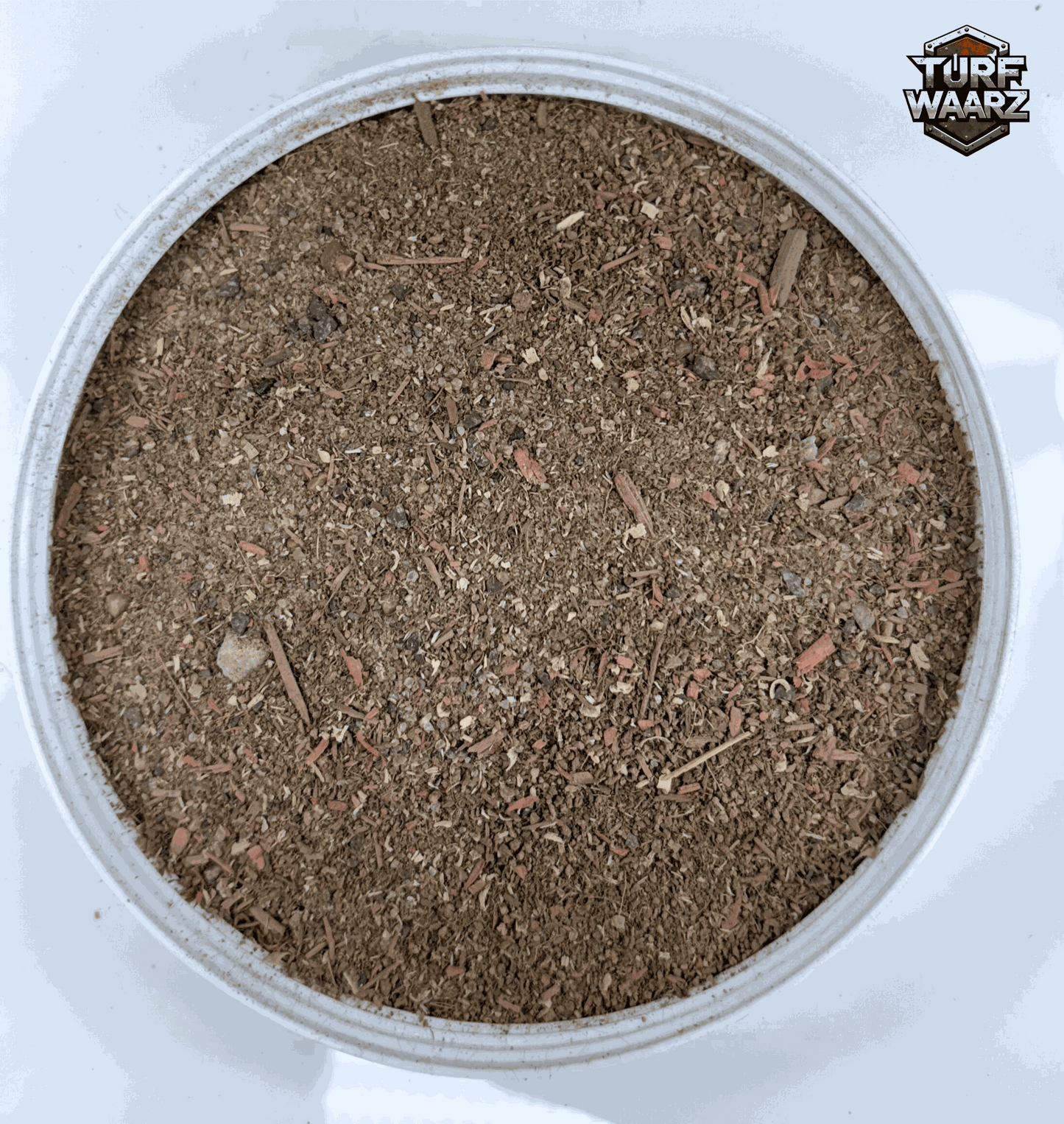 Turf Waarz Woodland Path miniature terrain material with gravels and natural debris in a round container for wargaming and modeling.