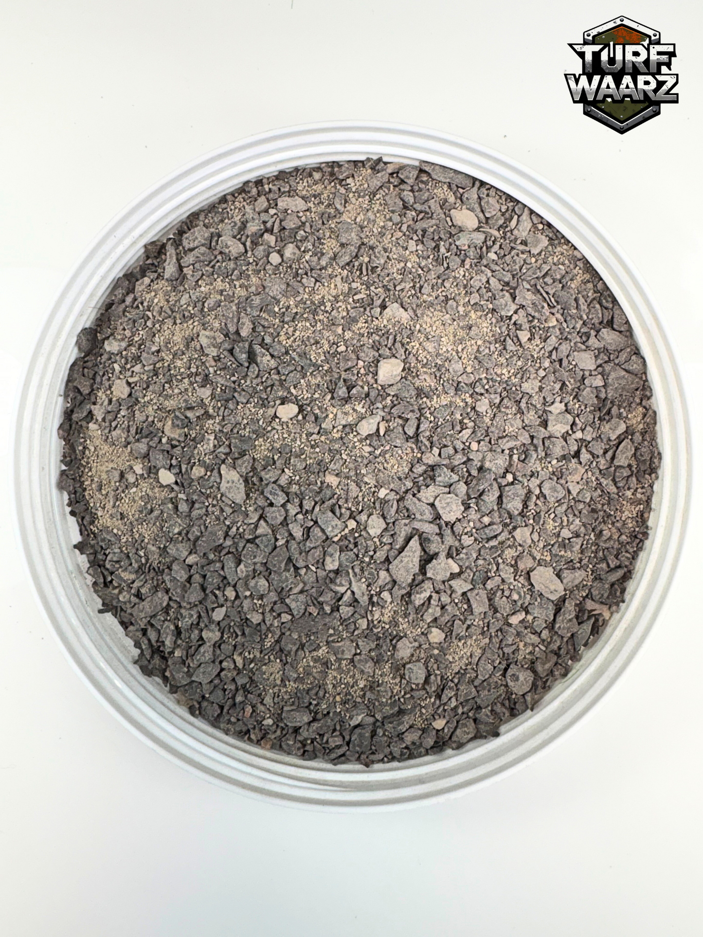 Grim Gray Rubble wargame terrain material in plastic container ideal for sci-fi urban battle scenes and miniature modeling.