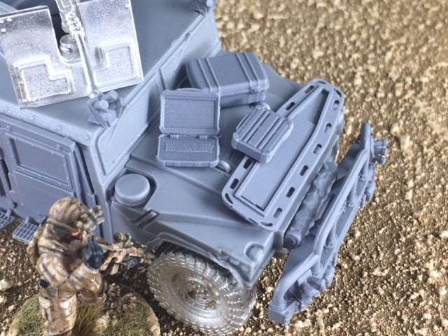 28mm scale combat laptop miniatures with open and closed laptops and a hard plastic travel case on a military vehicle model