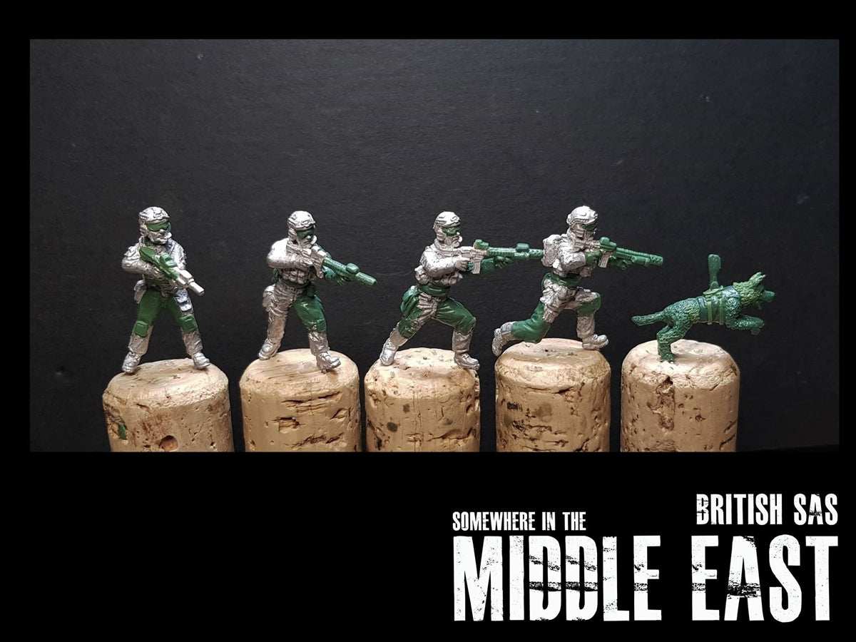 28mm SAS miniature set with four soldiers and a dog on cork bases against a black background