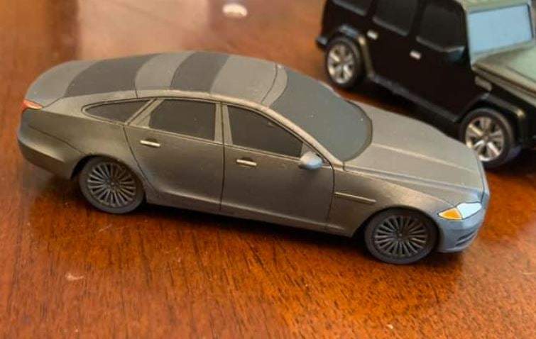 28mm modern Taguar 1/50 scale luxury car resin model unpainted on wooden surface