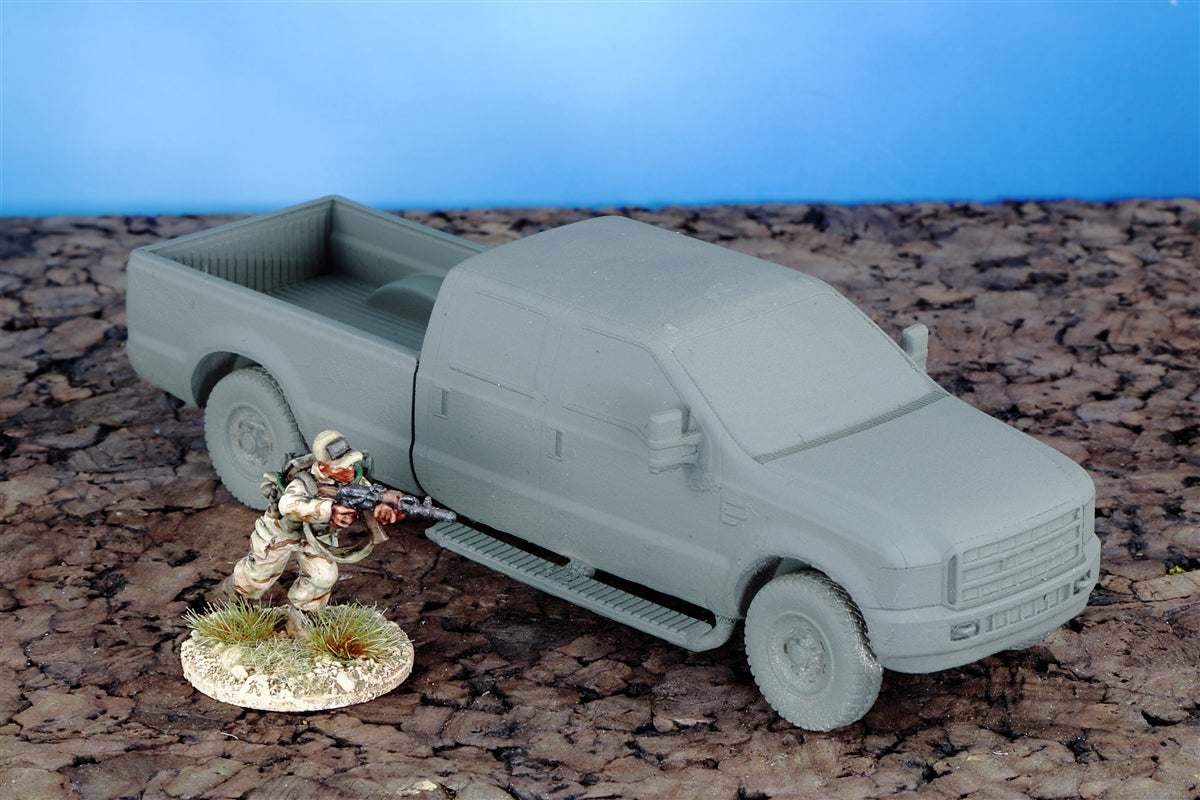 28mm scale resin model of modern T350 truck with metal wheels and side mirrors next to military figure on textured surface