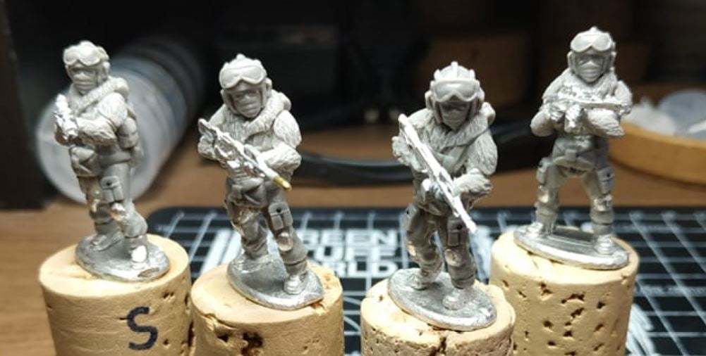 Set of four 28mm Naga Winter Fighters miniatures dressed for winter operations on cork bases