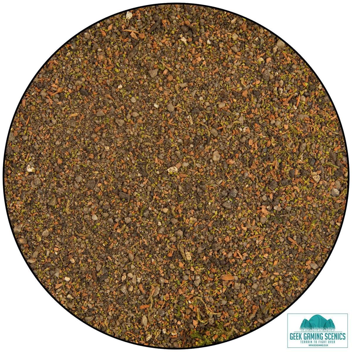 Close-up of realistic forest ground cover scatter material with mixed soil, sand, fine gravel, and foliage for model terrain and dioramas.