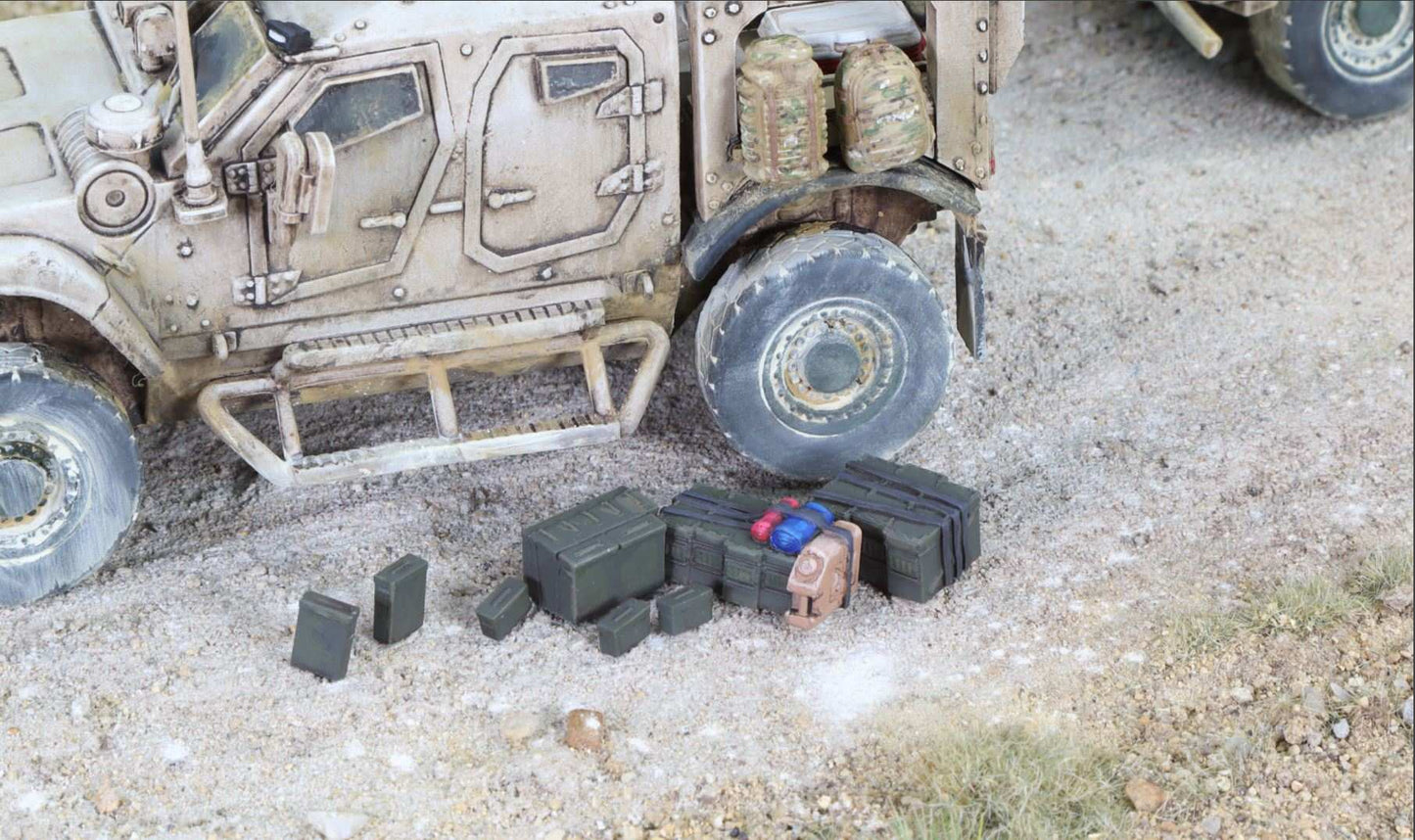 Set of seven 28mm modern ammunition cans displayed next to a military vehicle model on a gravel surface