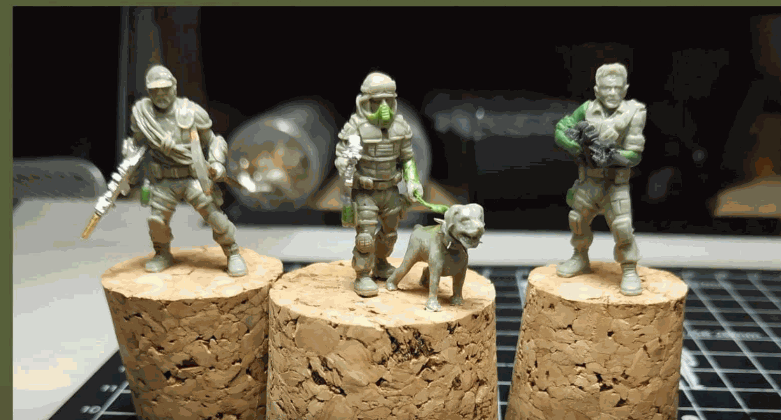 Set of four 28mm fighters miniature figures including soldier with dog on cork bases