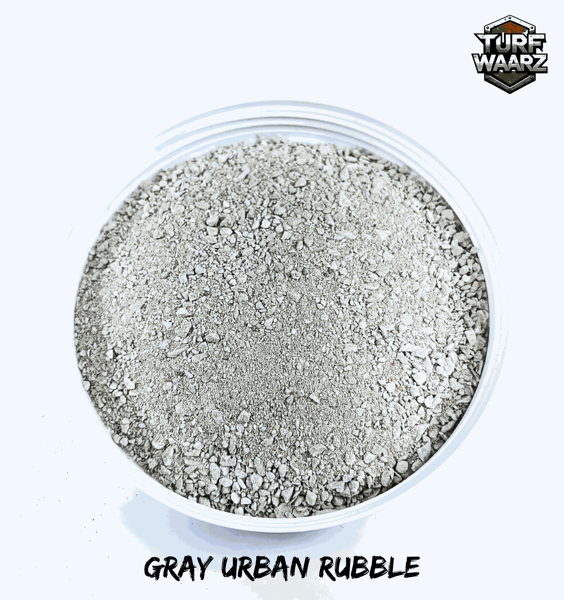 Gray Urban Rubble wargame terrain material in a plastic container for miniature and tabletop modeling.