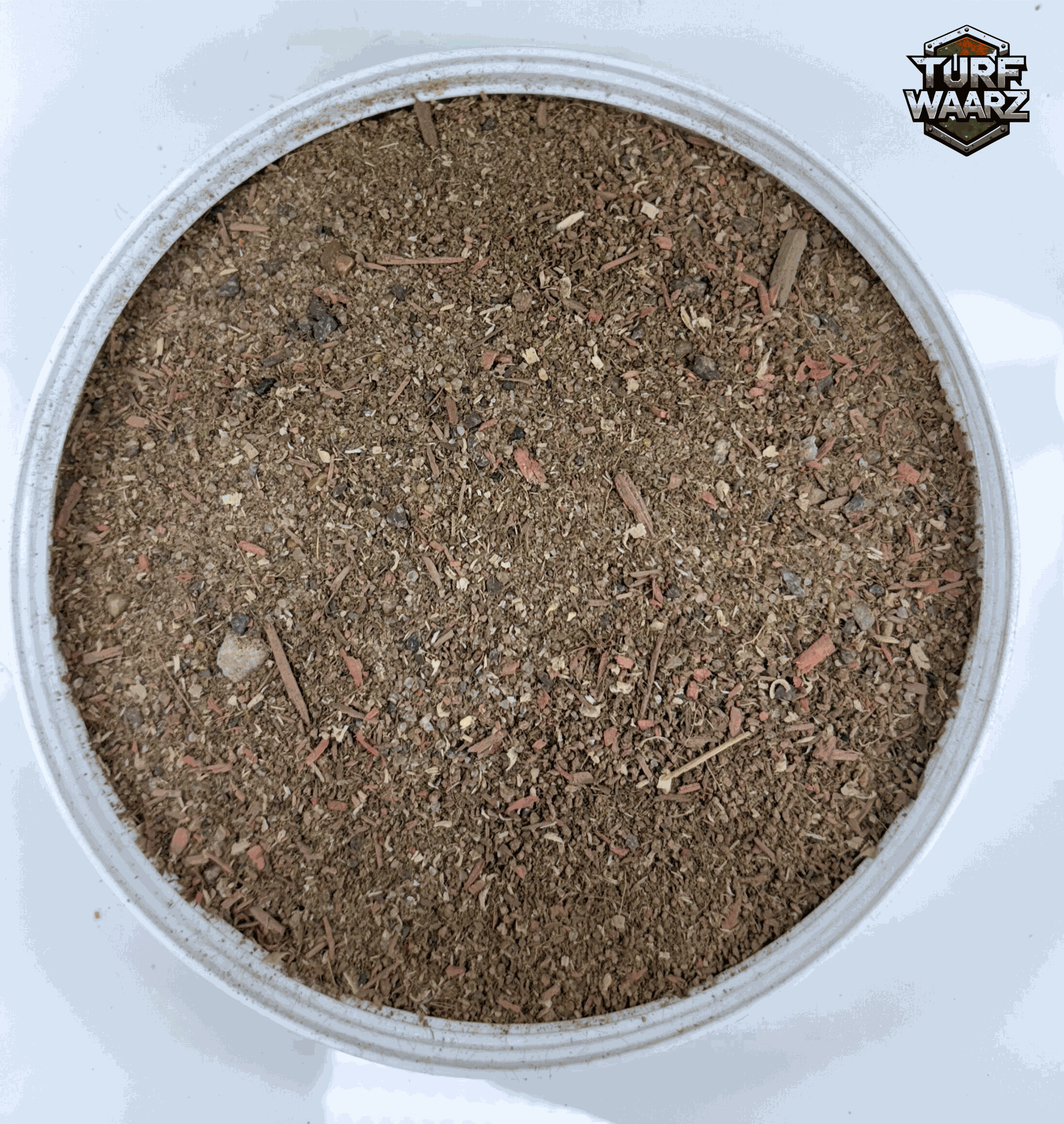Turf Waarz Woodland Path miniature terrain material with gravels and natural debris in a round container for wargaming and modeling.