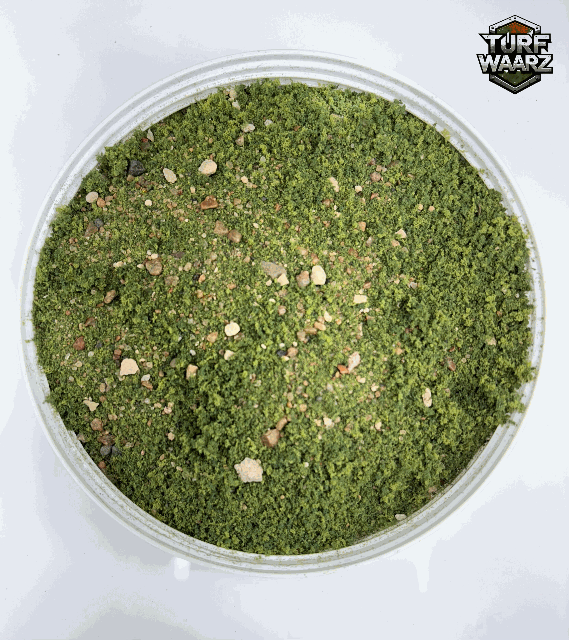 Turf Waarz Greenlands Wargame Turf in a plastic container with mixed gravels, sands, and natural materials for miniature and tabletop wargaming terrain.